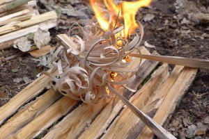 Lighting a fire with feathersticks