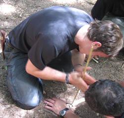 Using hand drill friction firelighting on the Intermediate Wilderness Bushcraft course