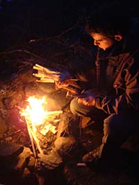 Paul Kirtley lighting fire on wilderness canoe trip