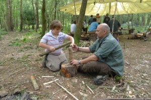 Adult and youngster working together on bushcraft project.