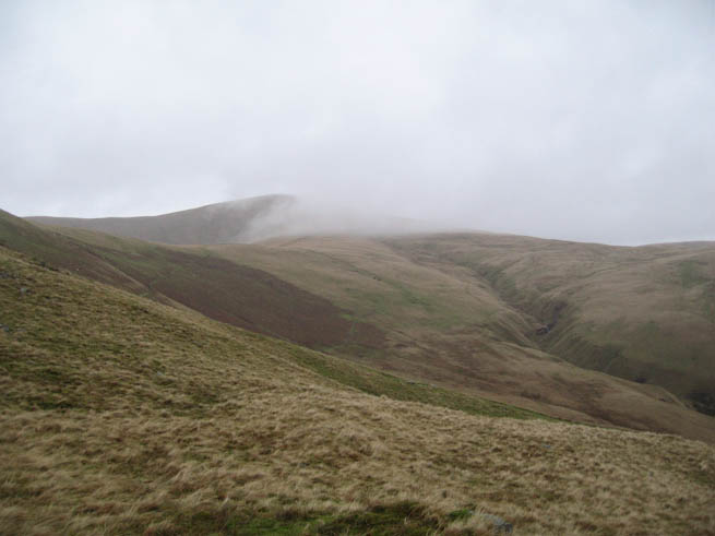 Howgills with cloud draped over grassy ridge