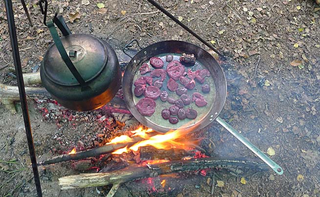 sliced deer heart and kidneys in frying pan over the fire