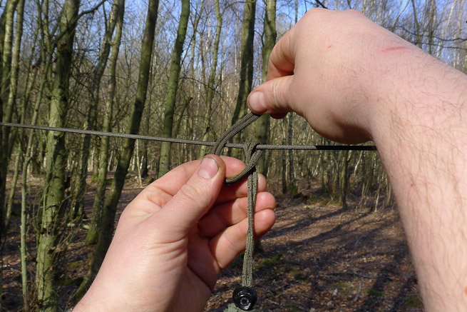 Tying a cow hitch with the doubled line of a draw-cord