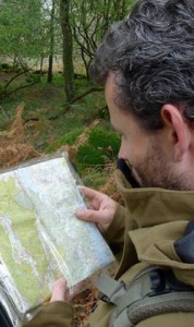 Man looking at map in the woods