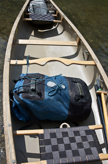 Canoe pack attached to canoe with a leash