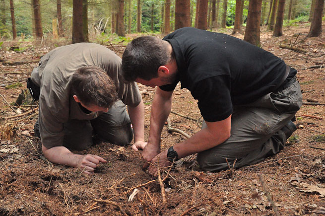 Bushcraft course participants collecting spruce roots