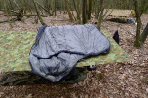 Sleeping bag opened out on top of a tarp