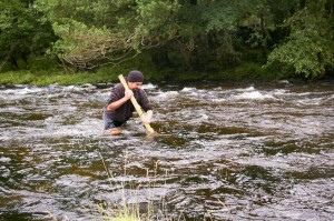 Using a strong pole to wade a river