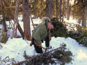 Paul Kirtley using an axe in the boreal forest