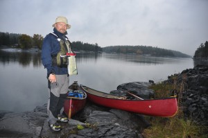 French River expedition participant Hamish Morton with some canoes in the background.