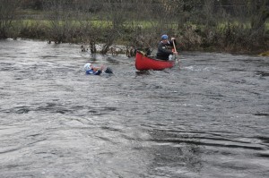 Canoeist going to rescue of swimmer