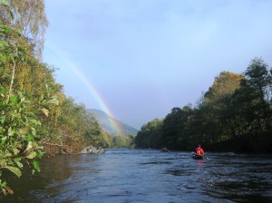 Canoeing on the Spey with a rainbow in distance