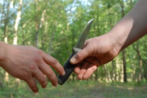 Note the point and sharp edge of the knife is away from both hands. Keep your fingers out of the way of the blade as you pass the knife.