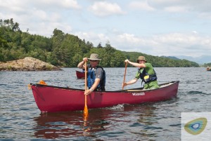Two men paddling a Wenonah Rogue canoe