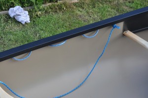 Looped cord with plastic piping on the inside of the boat.