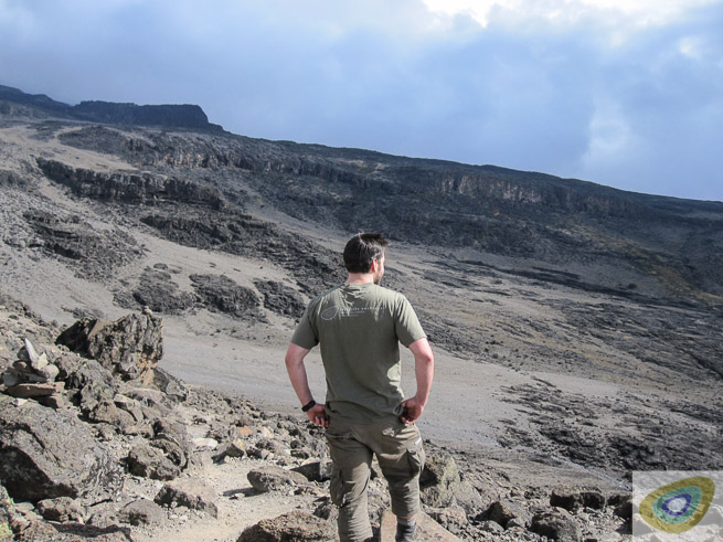 Henry Landon looking out from the volcanic slopes of Mount Kilimanjaro