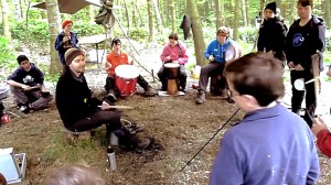 Cormac Byrne and school children drumming workshop in the woods