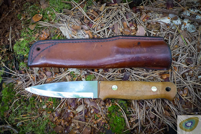 A well used Woodlore knife and sheath