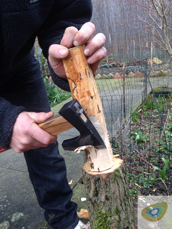 Carving a knife in a log