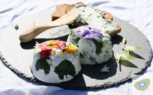 homemade cheese with seasonal flavouring and decorated with flowers