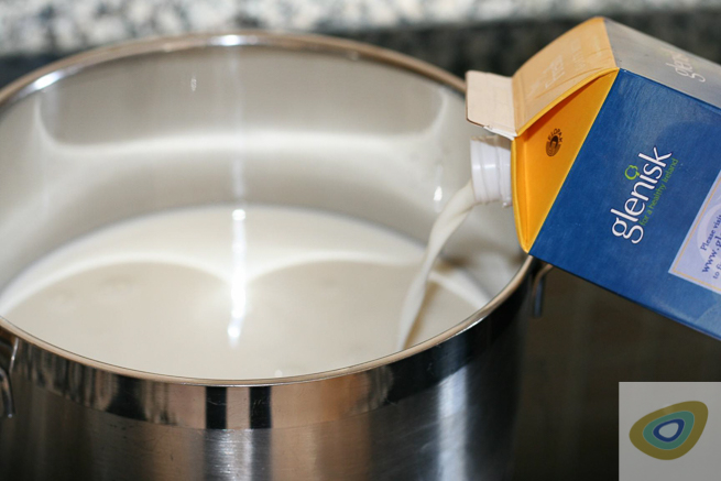 pouring milk into a suacepan