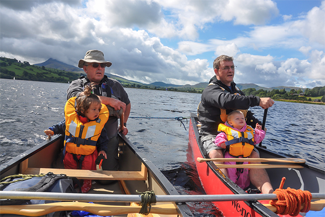 Ray Goodwin, daughter and friends canoeing rafted canoes in Wales