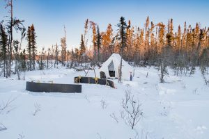To show a heated tent camp set up in the boreal forest