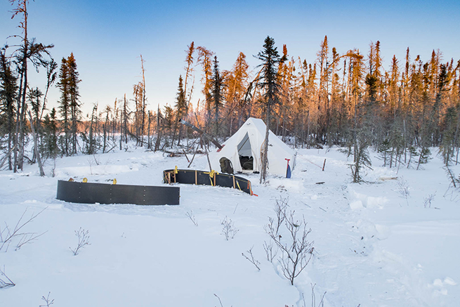 To show a heated tent camp set up in the boreal forest