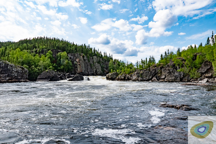 Rocky outcrops in boreal wilderness with white water falls